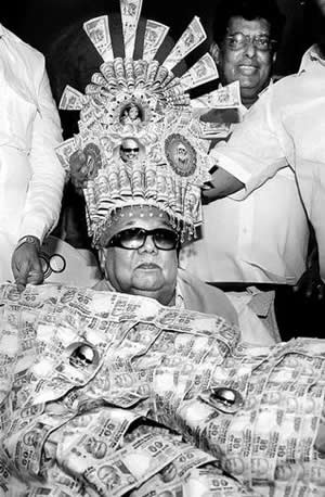 DMK president M. Karunanidhi adorned with a crown and a garland of currency notes on his 88th birthday in Chennai on Sunday.— Photo: PTI