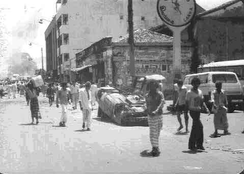 Buildings on Fire Cars overturned and looters walking away with goodies