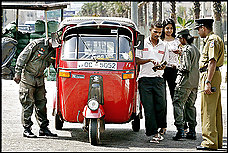 Sri Lankan soldiers check identity papers in Colombo, the capital, at end of a week of heightened violence by government troops and Tamil Tiger rebels.