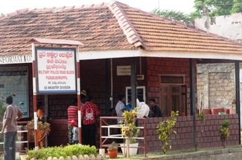 http://www.theweekendleader.com/admin/ckfinder/core/connector/upload/images/aug5-11-lanka%20military%20outpost%20in%20puthu%20with%20name%20board%20in%20engl%20and%20sinhala.jpg